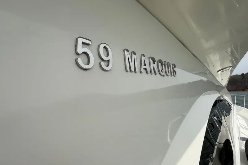 Slide: The Image of 2004 Marquis 59 yacht exterior with model name displayed on the hull. - 27