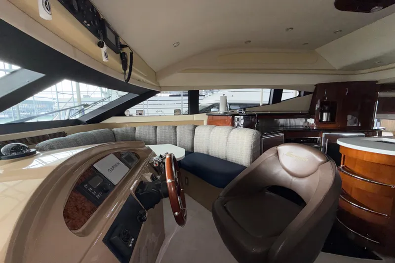 Slide: The Image of Luxurious 2004 Marquis 59 yacht interior with plush seating and modern navigation equipment. - 28