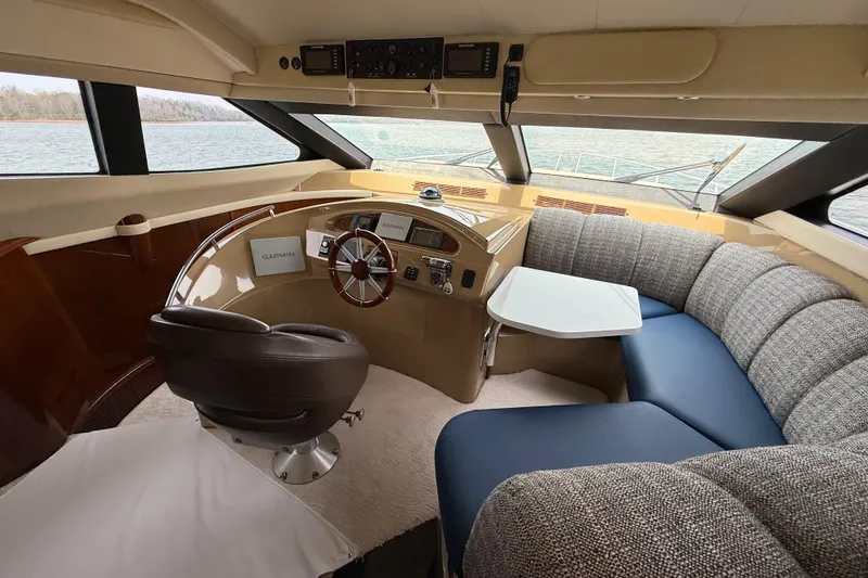 Slide: The Image of Luxurious 2004 Marquis 59 yacht interior with helm, plush seating, and navigation equipment. - 32