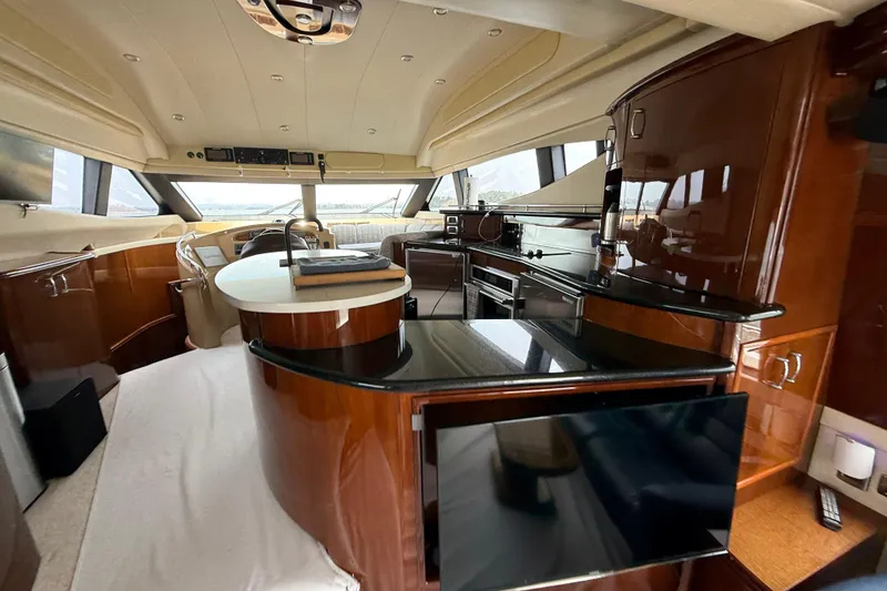 Slide: The Image of Luxurious interior of a 2004 Marquis 59 yacht with modern kitchen and helm. - 33