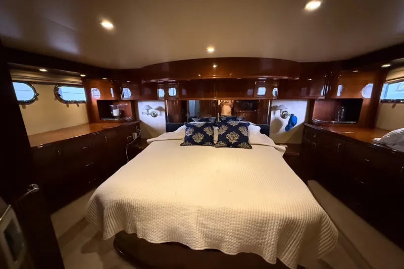 Slide: The Image of Luxurious 2004 Marquis 59 yacht bedroom with elegant wood finish and cozy bedding. - 35