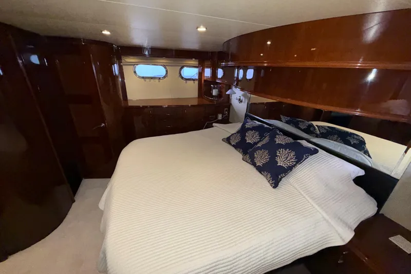 Slide: The Image of Luxurious 2004 Marquis 59 yacht bedroom with elegant wood finish and cozy bedding. - 36