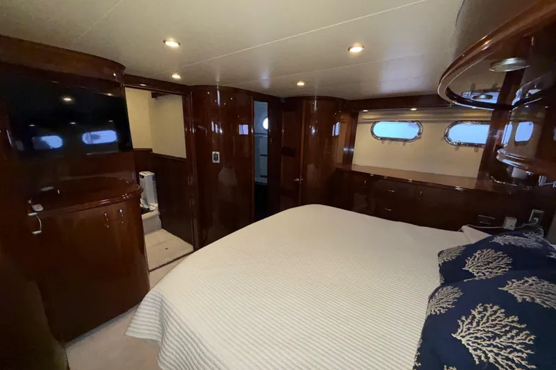 Slide: The Image of Luxurious 2004 Marquis 59 yacht bedroom with elegant wood finishes and cozy bedding. - 37
