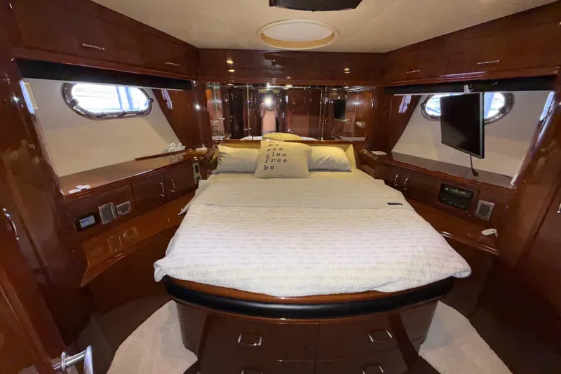 Slide: The Image of Luxurious 2004 Marquis 59 yacht bedroom with elegant wood finish and cozy bedding. - 40