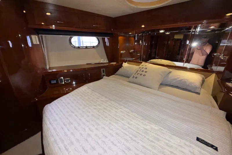 Slide: The Image of Luxurious bedroom interior of a 2004 Marquis 59 yacht with elegant wood finishes. - 42