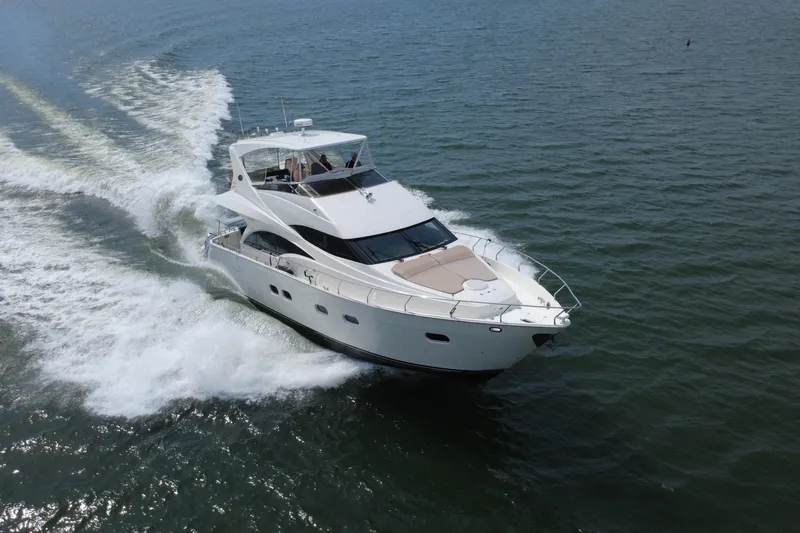Slide: The Image of Luxurious 2004 Marquis 59 yacht cruising swiftly on open water. - 7