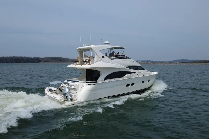 Slide: The Image of Luxurious 2004 Marquis 59 yacht cruising on open water. - 8