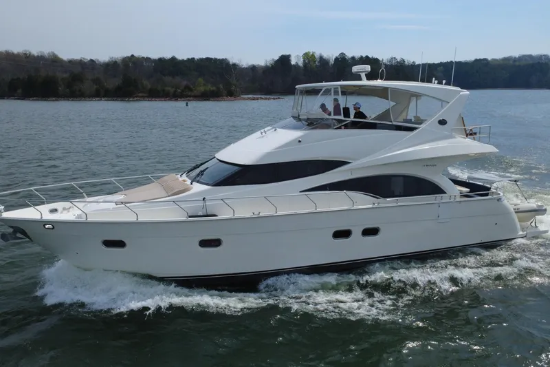 Slide: The Image of Luxury 2004 Marquis 59 yacht cruising on a scenic lake. - 9