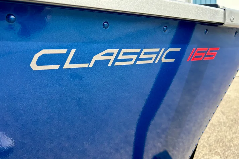 Slide: The Image of 2021 Alumacraft Classic 165 Sport boat, blue exterior with model name displayed. - 10
