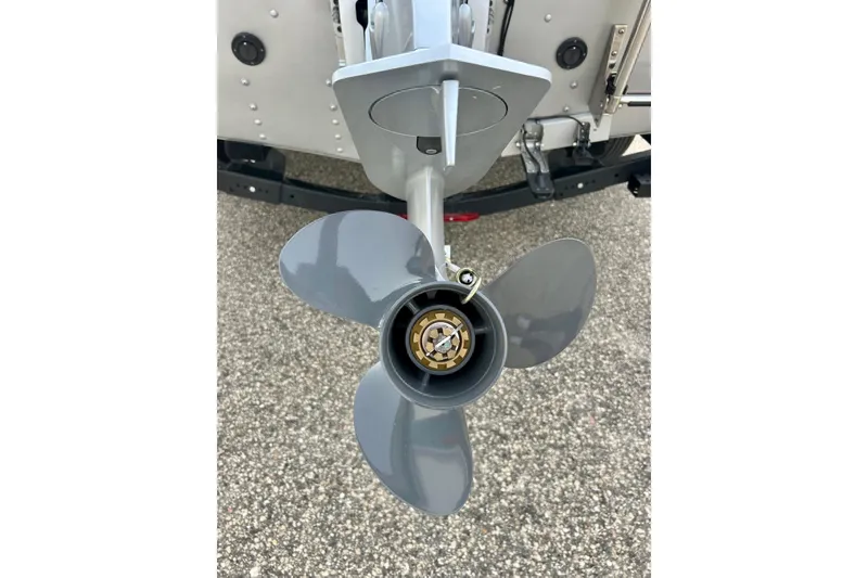 Slide: The Image of Propeller of 2021 Alumacraft Classic 165 Sport boat on pavement background. - 13