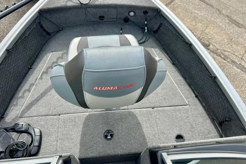 Slide: The Image of 2021 Alumacraft Classic 165 Sport boat interior with cushioned seat and carpeted deck. - 20