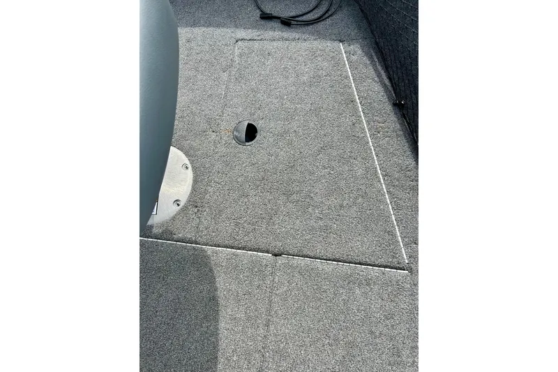 Slide: The Image of Carpeted deck of 2021 Alumacraft Classic 165 Sport boat, featuring a storage compartment. - 21