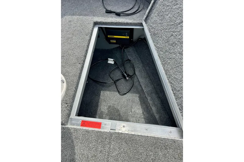 Slide: The Image of Open storage compartment in 2021 Alumacraft Classic 165 Sport boat, showing interior wiring. - 22