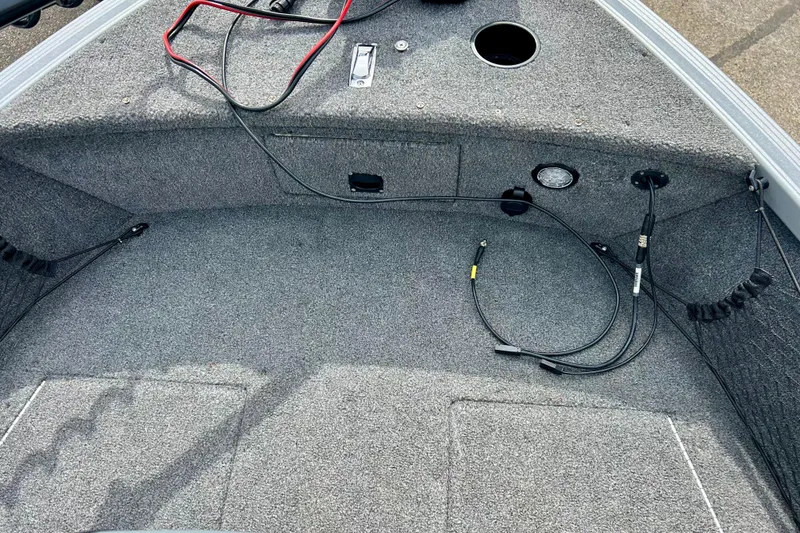 Slide: The Image of 2021 Alumacraft Classic 165 Sport boat interior with cables and carpeted flooring. - 24