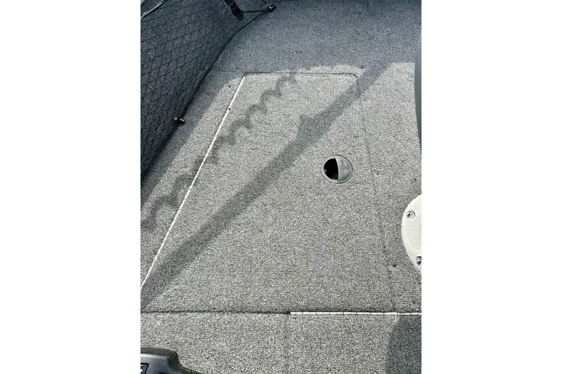 Slide: The Image of 2021 Alumacraft Classic 165 Sport boat interior with carpeted flooring and storage compartment. - 25