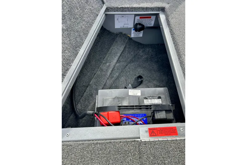 Slide: The Image of Battery compartment of 2021 Alumacraft Classic 165 Sport boat, featuring secure wiring. - 26