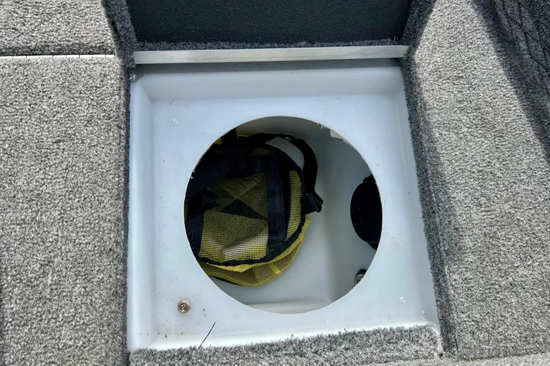 Slide: The Image of Storage compartment in 2021 Alumacraft Classic 165 Sport boat, featuring a circular hatch. - 29
