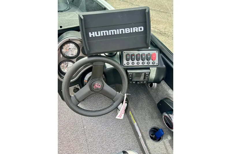 Slide: The Image of 2021 Alumacraft Classic 165 Sport dashboard with Humminbird fish finder and steering wheel. - 32