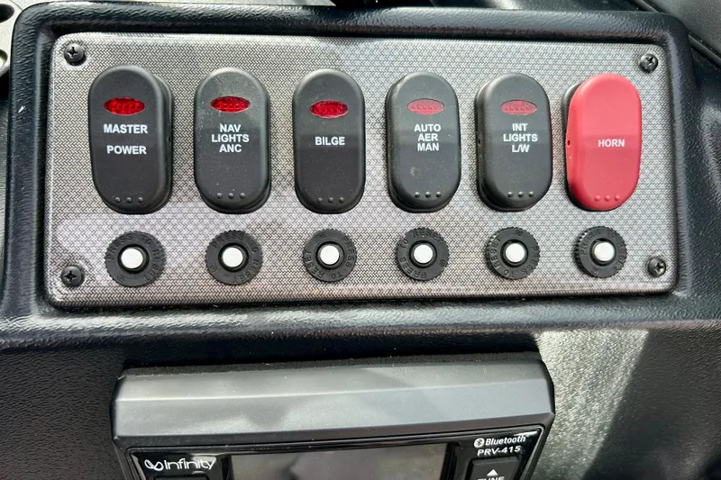 Slide: The Image of Control panel of 2021 Alumacraft Classic 165 Sport boat with labeled switches and Bluetooth system. - 34