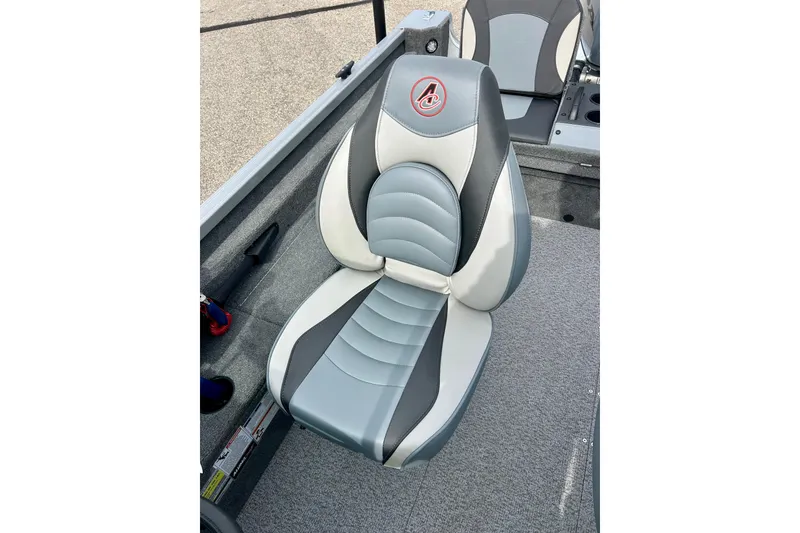 Slide: The Image of 2021 Alumacraft Classic 165 Sport boat seat, gray and white design, on carpeted deck. - 38