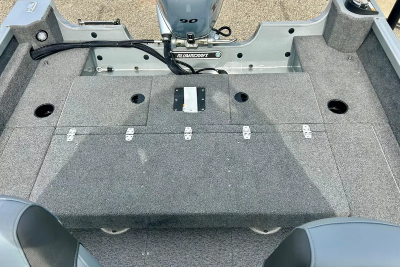 Slide: The Image of 2021 Alumacraft Classic 165 Sport boat interior with carpeted deck and motor. - 42