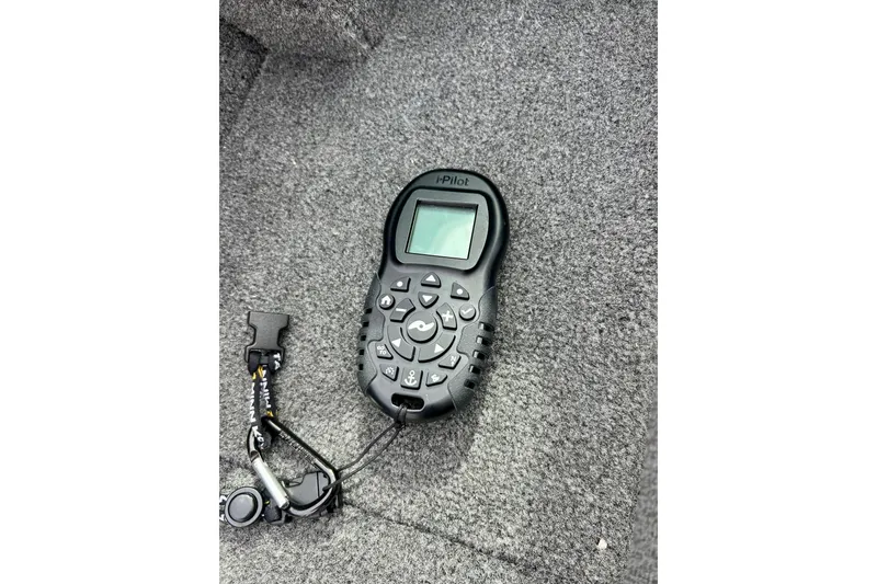 Slide: The Image of Remote control on carpeted surface of 2021 Alumacraft Classic 165 Sport boat. - 49