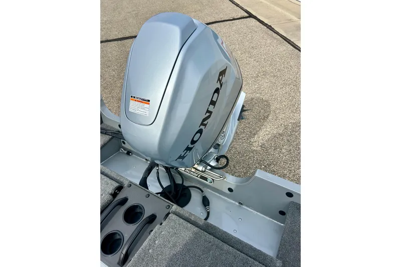 Slide: The Image of 2021 Alumacraft Classic 165 Sport with Honda outboard motor, featuring cup holders. - 51