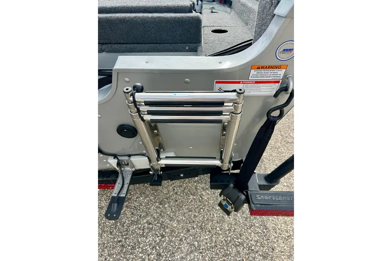 Slide: The Image of 2021 Alumacraft Classic 165 Sport boat ladder and warning labels. - 54