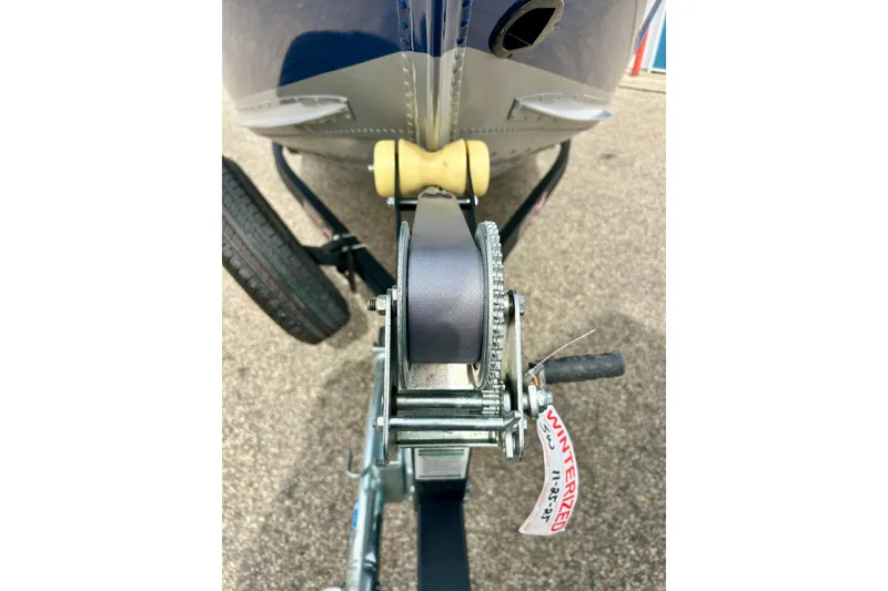 Slide: The Image of 2021 Alumacraft Classic 165 Sport boat trailer winch close-up, showing winterized tag. - 56
