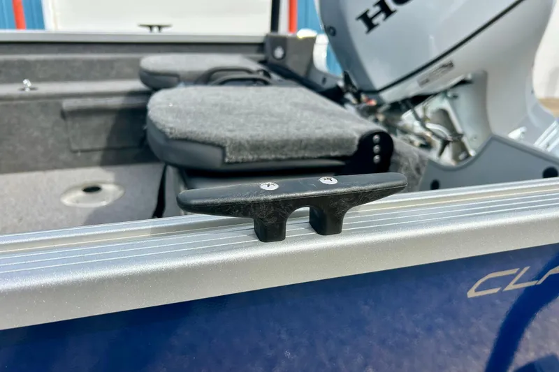Slide: The Image of 2021 Alumacraft Classic 165 Sport boat interior with Honda motor and cleat detail. - 60