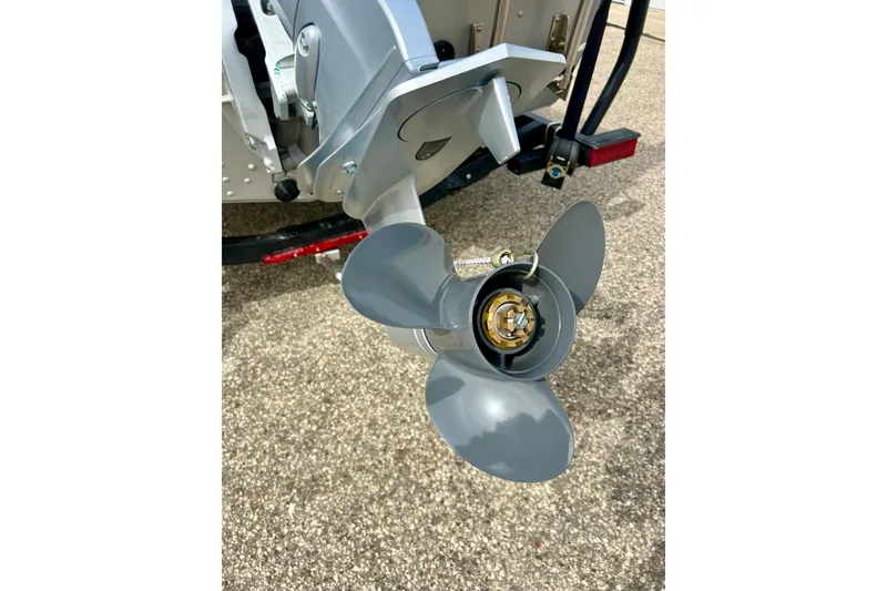 Slide: The Image of Propeller of 2021 Alumacraft Classic 165 Sport boat on pavement background. - 68