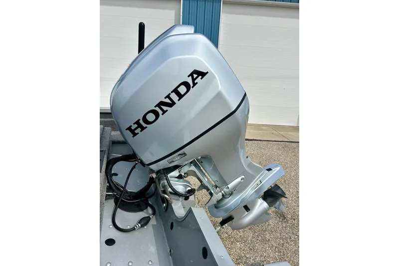 Slide: The Image of Silver Honda outboard motor on 2021 Alumacraft Classic 165 Sport boat. - 70