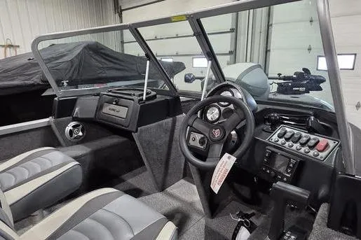 Slide: The Image of 2021 Alumacraft Classic 165 Sport boat interior with steering wheel and dashboard controls. - 8