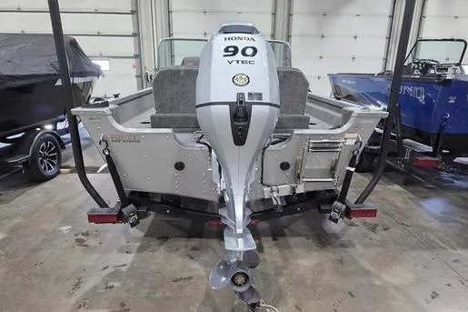 Slide: The Image of 2021 Alumacraft Classic 165 Sport boat with Honda 90 VTEC engine in a garage. - 9