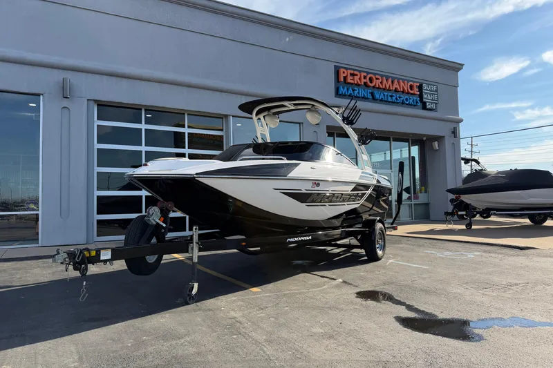 The Image of 2014 Moomba Mondo boat on trailer outside Performance Marine Watersports dealership. - 1