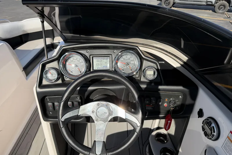 Slide: The Image of 2014 Moomba Mondo boat dashboard with steering wheel and instrument panel. - 14