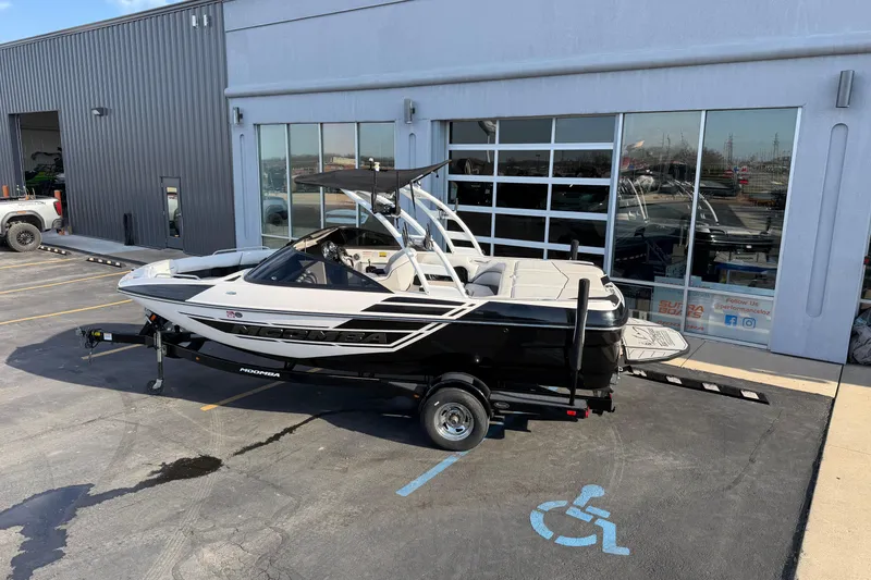 Slide: The Image of 2014 Moomba Mondo boat on trailer outside dealership, parked in a handicap space. - 3