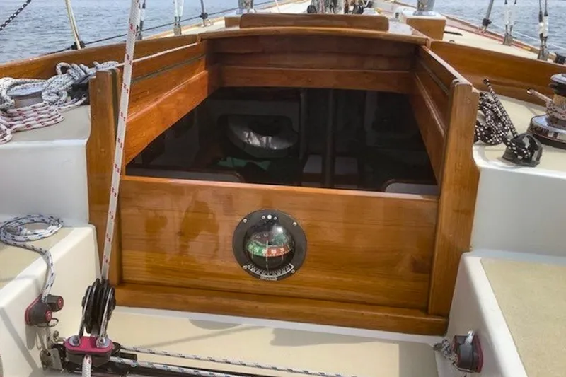 Slide: The Image of 1988 Morris Frances 26 sailboat cockpit with wooden hatch and nautical ropes. - 13
