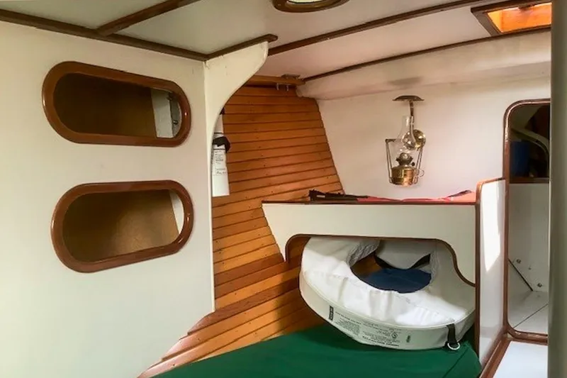 Slide: The Image of Interior of 1988 Morris Frances 26 sailboat with wooden accents and nautical decor. - 17