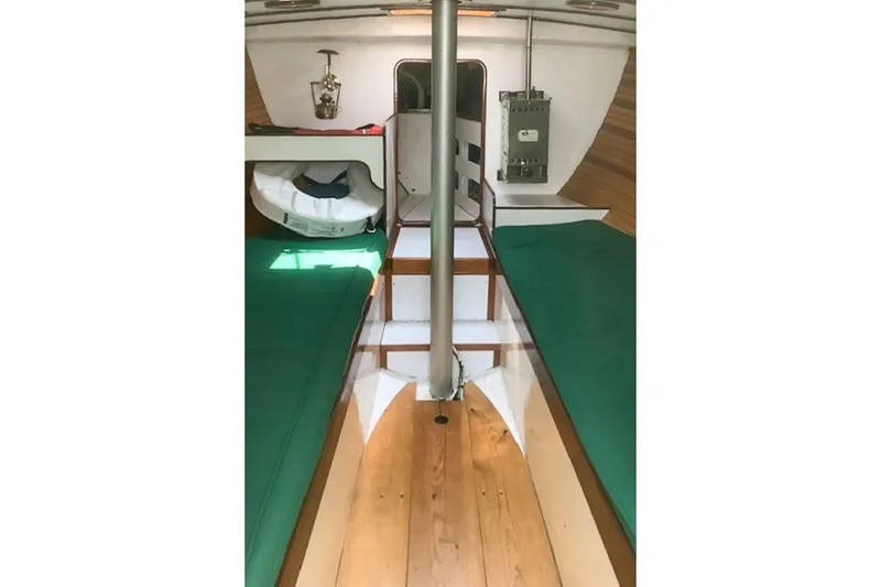 Slide: The Image of Interior of 1988 Morris Frances 26 sailboat with green cushions and wooden flooring. - 19