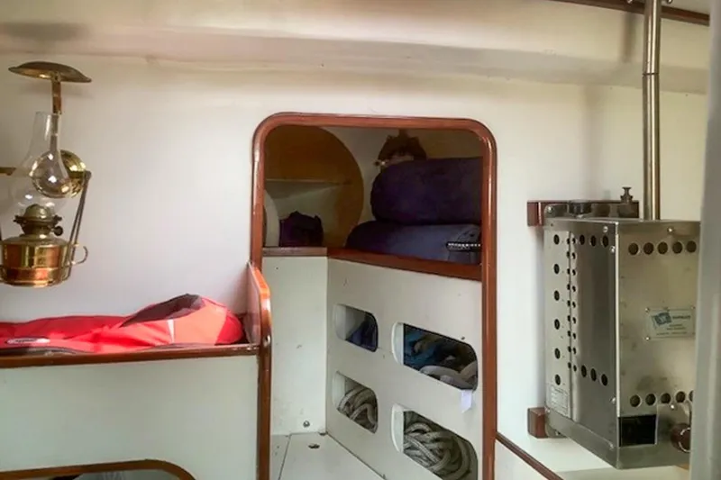 Slide: The Image of Interior of a 1988 Morris Frances 26 sailboat, featuring cozy sleeping quarters and nautical decor. - 20