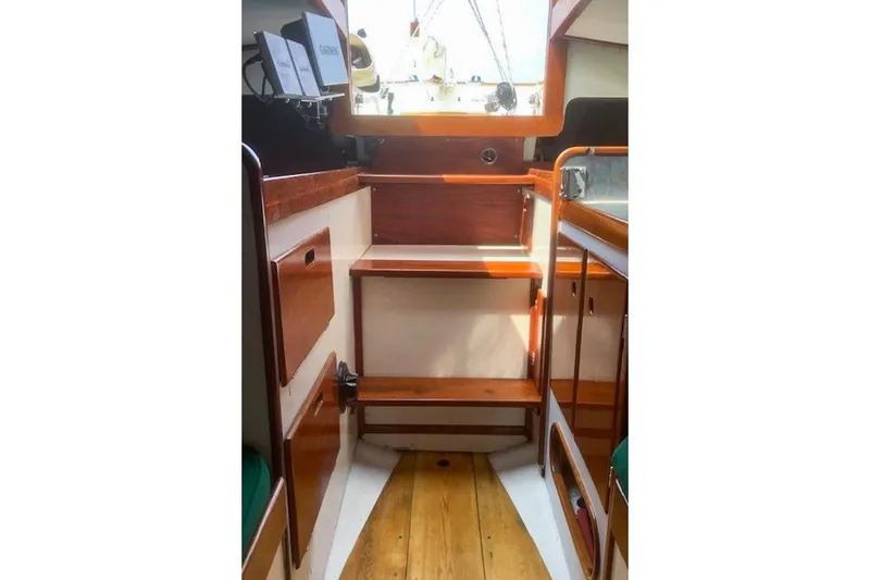 Slide: The Image of Interior of 1988 Morris Frances 26 sailboat with wooden cabinetry and steps. - 26