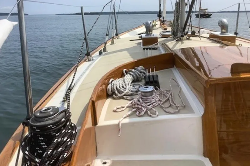 Slide: The Image of 1988 Morris Frances 26 sailboat deck with ropes and winches on calm water. - 6