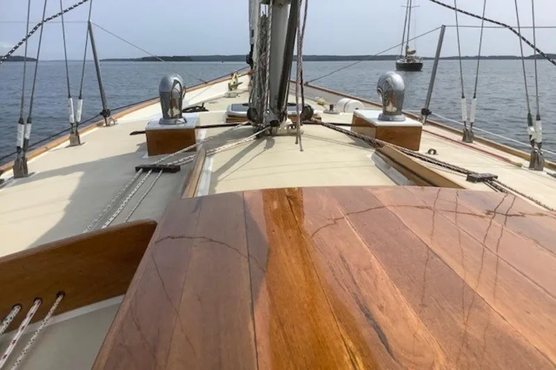 Slide: The Image of Deck view of 1988 Morris Frances 26 sailboat with polished wood finish on calm water. - 9