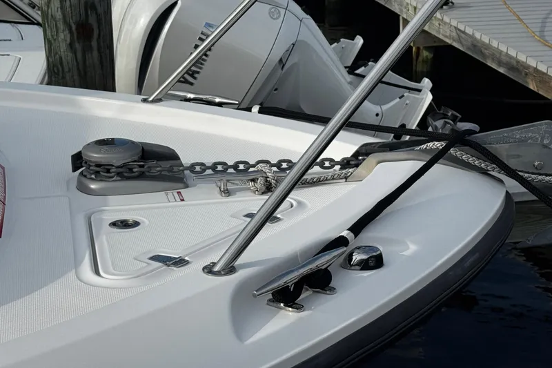 Slide: The Image of 2016 Boston Whaler 315 Conquest boat deck with anchor chain and cleat. - 10