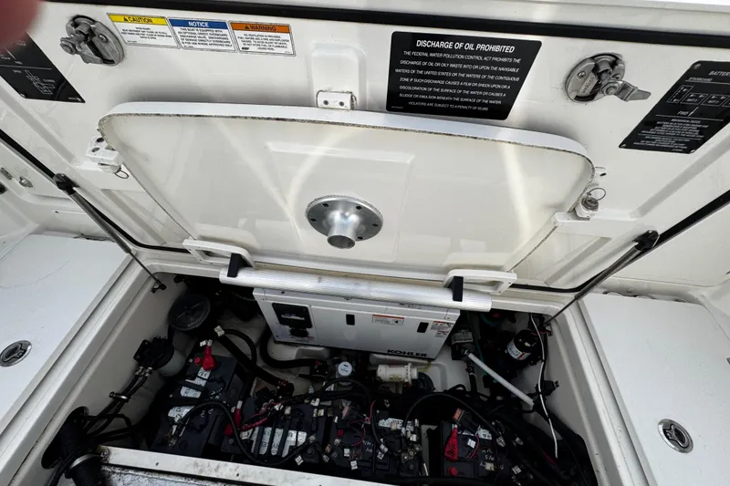 Slide: The Image of Engine compartment of a 2016 Boston Whaler 315 Conquest boat, showing battery and wiring. - 13