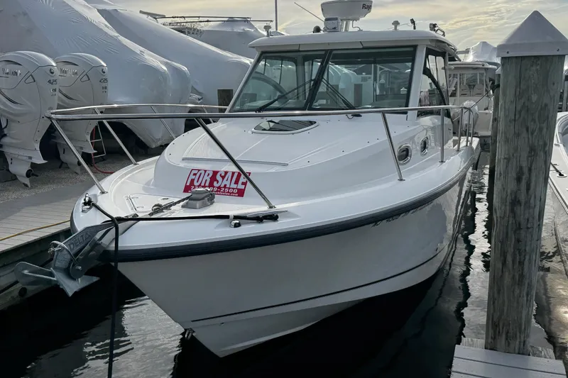 Slide: The Image of 2016 Boston Whaler 315 Conquest boat for sale at marina dock. - 2