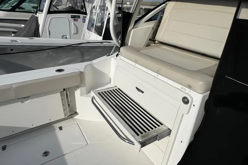 Slide: The Image of 2016 Boston Whaler 315 Conquest interior with seating and storage area. - 20