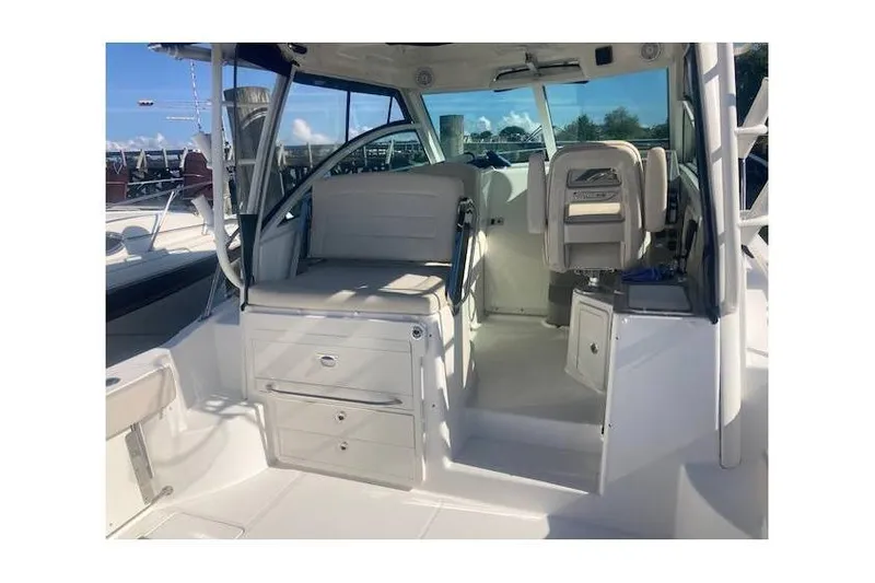 Slide: The Image of 2016 Boston Whaler 315 Conquest interior with seating and storage compartments. - 24