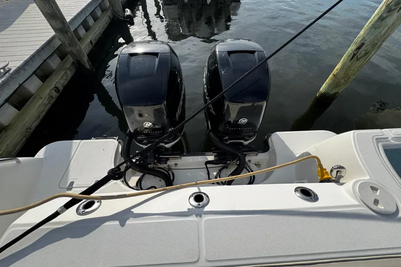 Slide: The Image of 2016 Boston Whaler 315 Conquest with dual outboard engines docked at marina. - 28